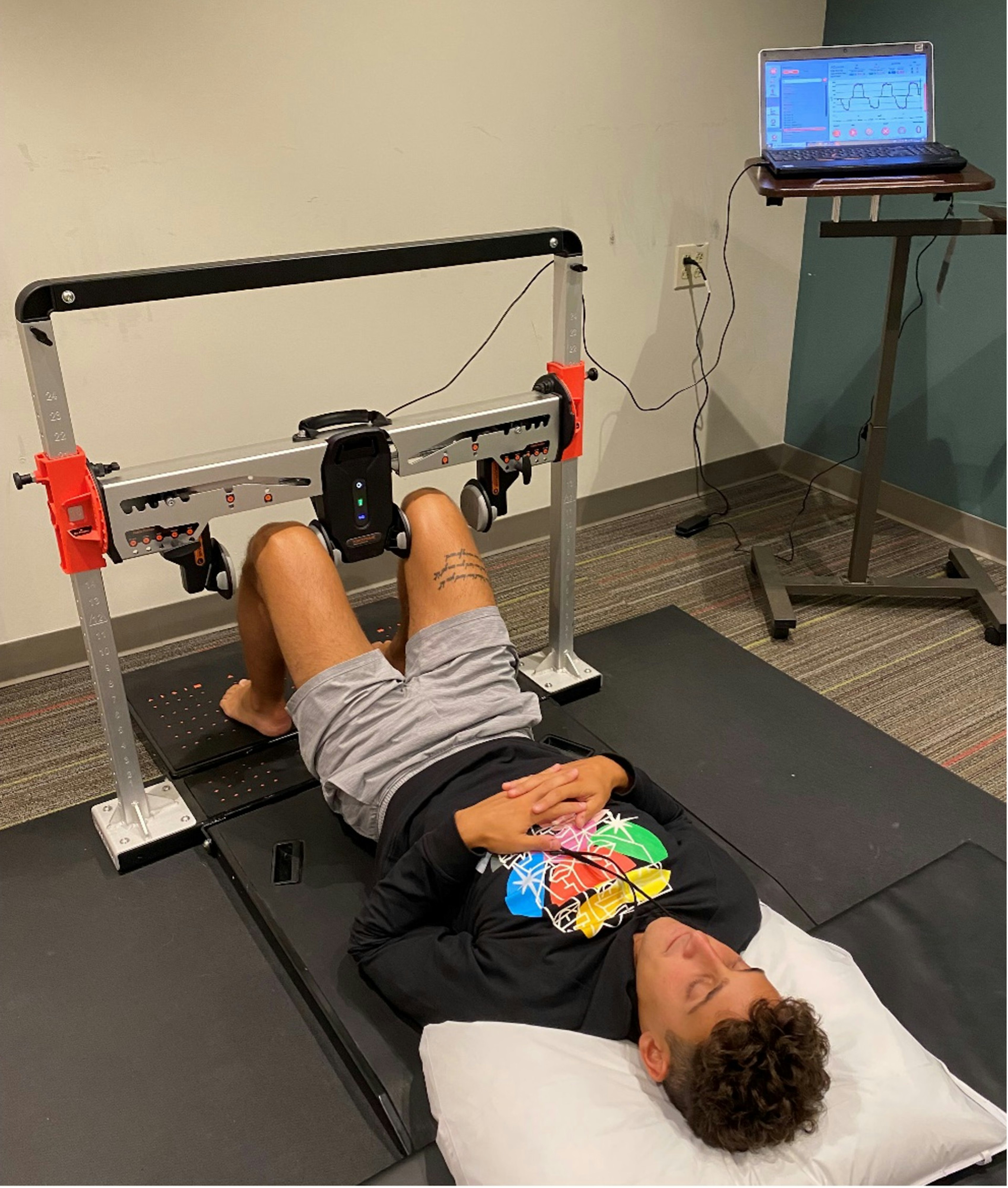 A collegiate soccer player returning for muscle strength testing at the tail-end of his rehab protocol, testing hip adduction at 60°.