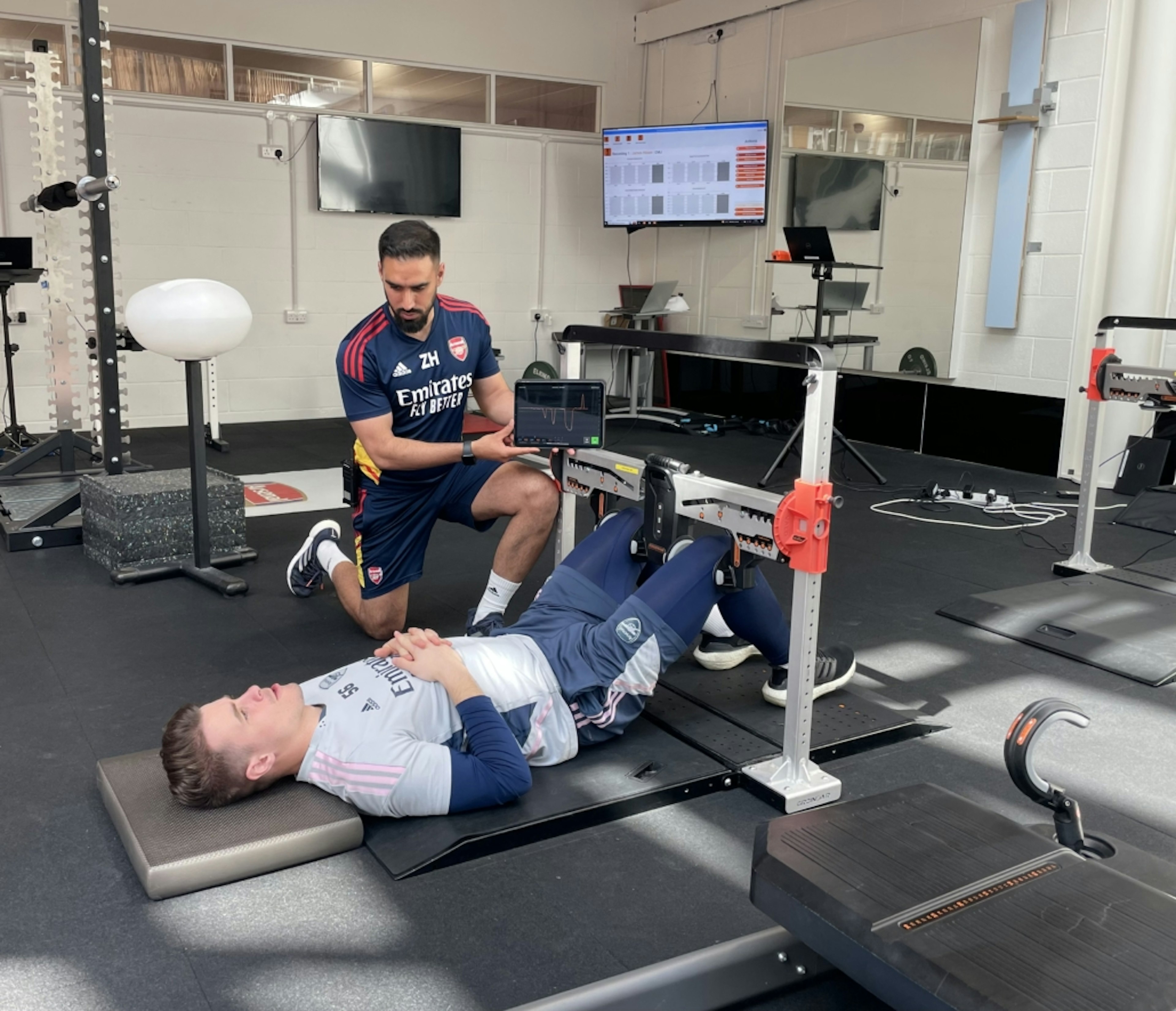 Physiotherapist Zubair Haleem performing hip abduction/adduction using ForceFrame at Arsenal F.C.