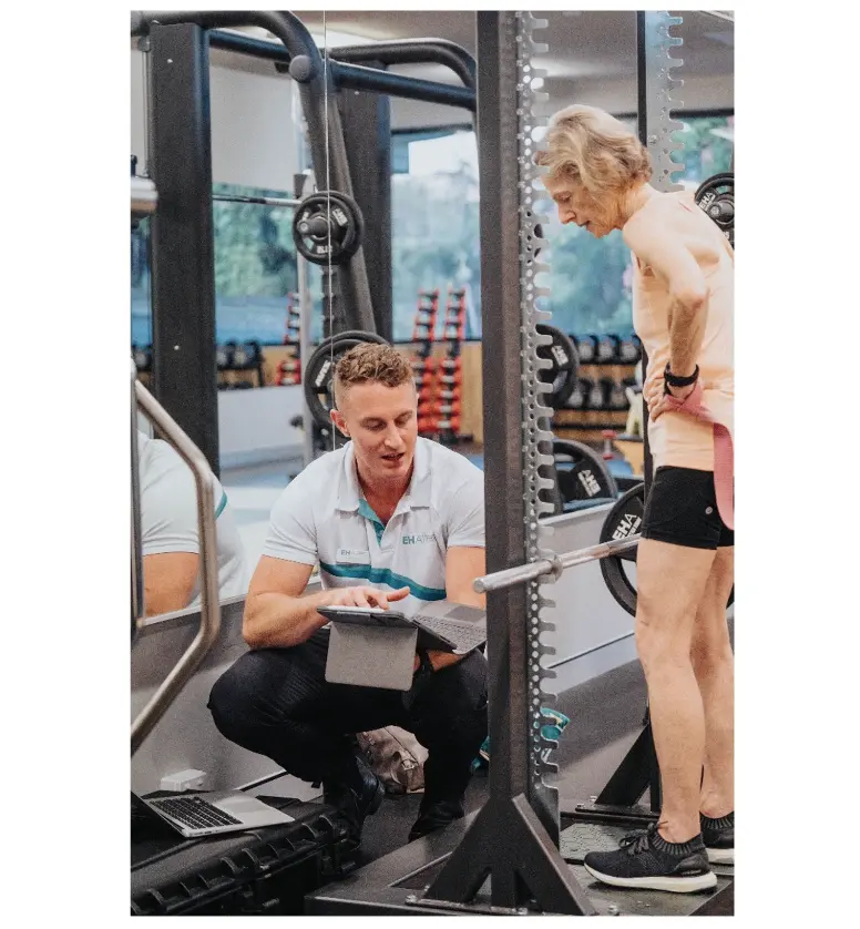 Exercise Physiologist and founder – Mitchell – showing a client real-time results from a ForceDecks assessment.