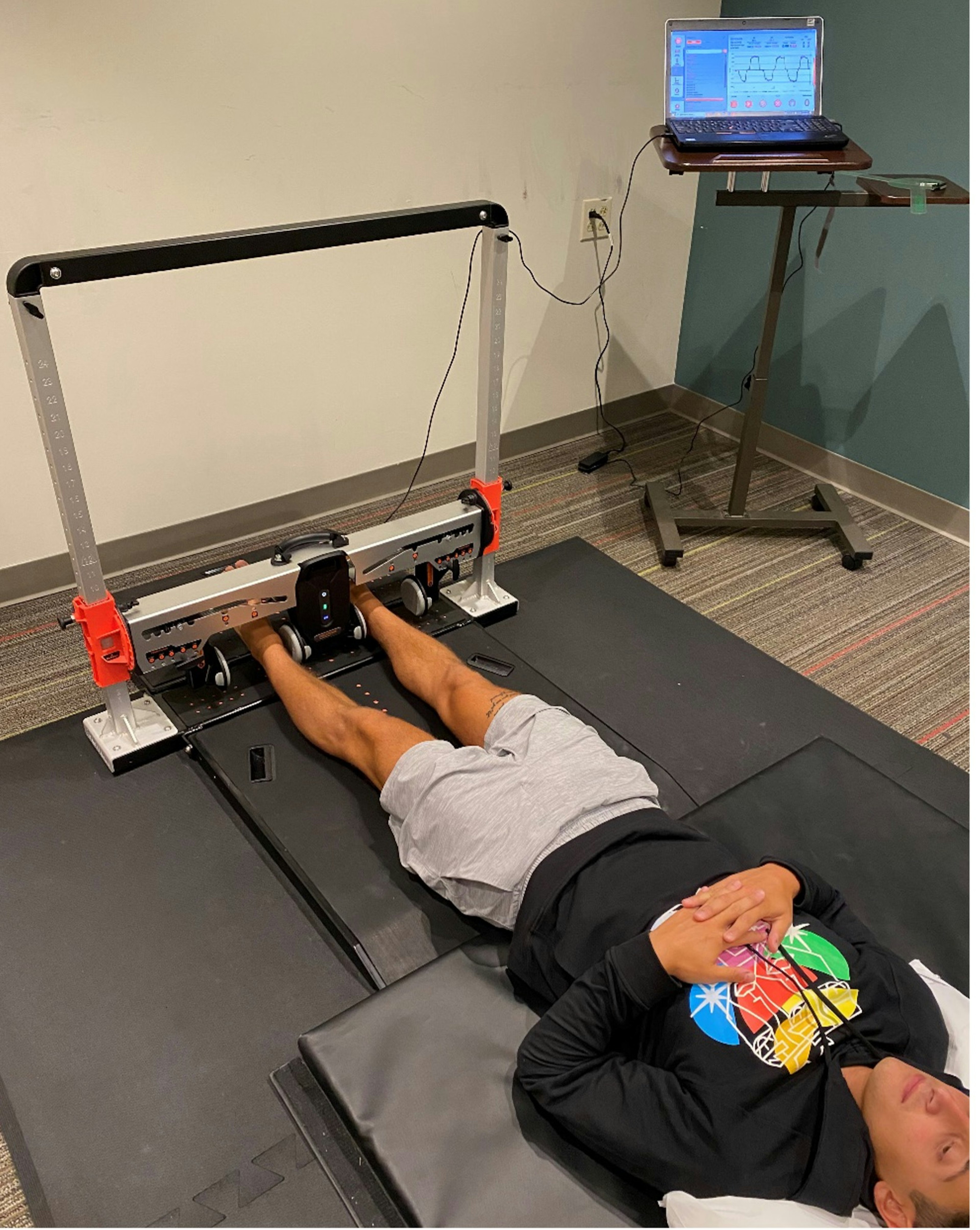 A collegiate soccer player returning for muscle strength testing at the tail-end of his rehab protocol, testing maximal hip adduction strength at 0° (long lever).